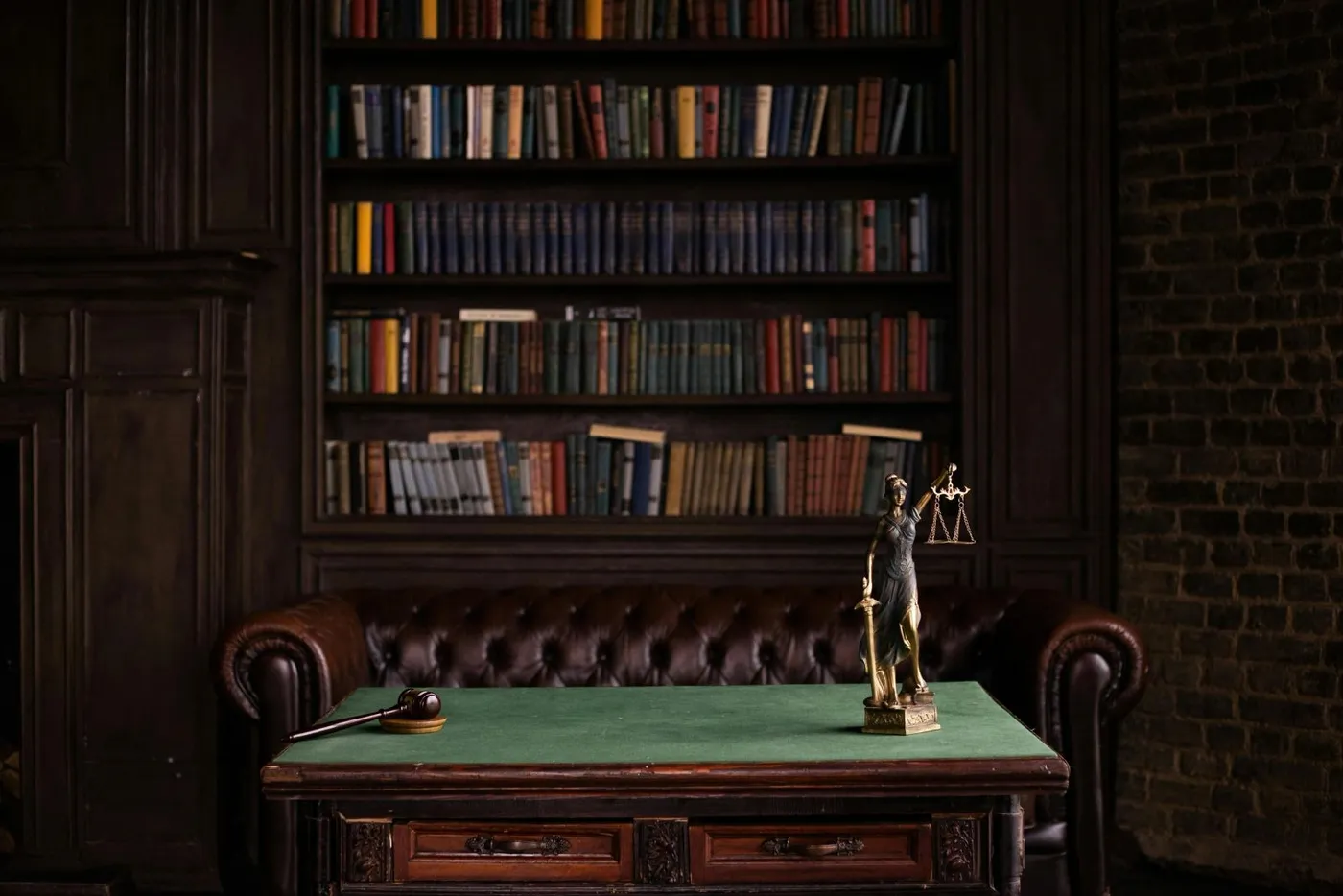 Law library with scales of justice on a desk
