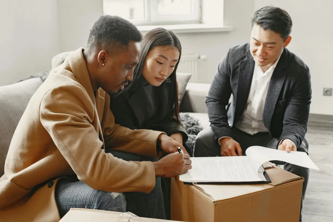 Couple signing documents with a professional at home